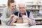 Senior Man With Teacher In Pottery Class