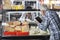 Senior Man Using Digital Tablet In Cheese Shop