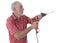 Senior man using an electric drill