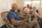 Senior man using laptop while senor couple using digital tablet at nursing home