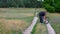 Senior man walking with very old rust bicycle on country road and being dissatisfaction about quality of the bi