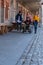 Senior man in a wheelchair accompanied by happy youngsters