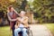 Senior man in wheelchair with caregiver daughter