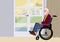 Senior man in a wheelchair gazing towards the door