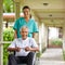 Senior man in wheelchair with nurse