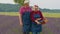 Senior man woman grandfather grandmother farmers gathering lavender flowers on summer field garden