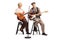 Senior man and woman sitting and playing electric guitars