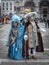 Senior man and woman stand in medieval carnival costumes and masks in Piazza San Marco in Venice