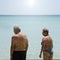 Senior man and woman in swimsuit are waiting together on a beach. Seniors on vacation concept