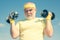 Senior man workout in rehabilitation center. Lifting dumbbells. Health club or rehabilitation center for elderly aged