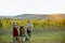 Senior man with young woman pressing grapes for wine production