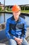 Senior manual worker sitting near water filtration unit