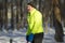 Senior mature man with black moustache wearing bright outfit making workout on a sports ground in the park