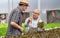 Senior mature man and customer talking about quality of organic vegetables.