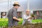 Senior mature man and customer talking about quality of organic vegetables.