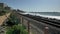 Senior mature woman going on train to railroad track beautiful landscape pacific coast Orange county San Clemente