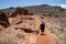 Senior mature woman tourist walks the path at Wupatki National Monument to explore the puebloes