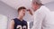 Senior medical doctor checking basketball player\'s eyes with fla