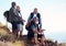 Senior, men and hiking in nature, relax and calm, sitting and happy on blue sky background. Elderly, friends and man