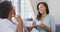 Senior mixed race woman drinking tea with her daughter in social distancing