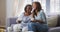 Senior mixed race woman drinking tea with her daughter in social distancing