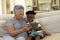 Senior mixed race woman with her grandson at home