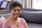 Senior mixed race woman sitting on a couch