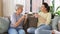 Senior mother and adult daughter drinking coffee