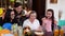 Senior mother with daughter and granddaughters blowing candles on birthday cake