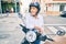 Senior motorcyclist man smiling happy wearing moto helmet at the city