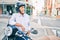 Senior motorcyclist man smiling happy wearing moto helmet at the city