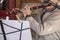 Senior musician -older man plays a flute -closeup with music on stand and microphone