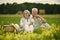 Senior nice couple sitting on the grass in the field