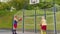 Senior old basketball team man and woman playing game, throwing ball into basket at stadium court