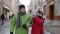 Senior old couple grandmother and grandfather in colorful winter jackets walking in winter city