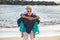 Senior old people couple have fun together at the beach in summer holiday vacation - tourist mature man and woman carrying each