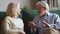 Senior old spouses couple talking sitting on sofa at home