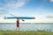 Senior paddler walking with a stand up paddleboard