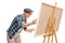 Senior painter painting on a canvas