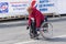 Senior participant in a wheelchair hurrying to finish line