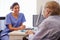 Senior Patient Having Consultation With Nurse In Office