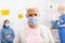 Senior Patient Infected With Coronavirus Wearing Mask Posing In Hospital