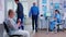 Senior patient signing documents in hospital waiting area