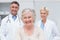 Senior patient smiling with doctors in clinic