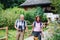 A senior pensioner couple with binoculars hiking,holding hands.