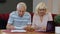 Senior pensioner couple checking and calculating domestic bills bank loan payment doing paperwork