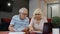 Senior pensioner couple checking and calculating domestic bills bank loan payment doing paperwork