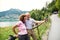 Senior pensioner couple hikers standing in nature, taking selfie.