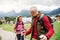 Senior pensioner couple with nordic walking poles hiking in nature, talking.