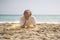 Senior pensioner sitting relaxed on the beach - retired old man on his 70s looking at the sea thoughtful and contemplative with